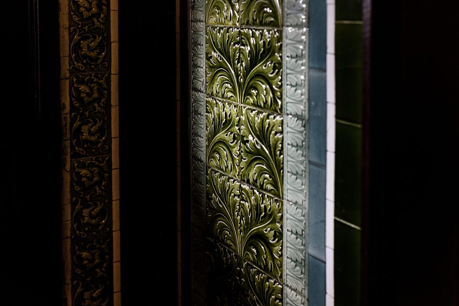 Wall with ornate green tiles
