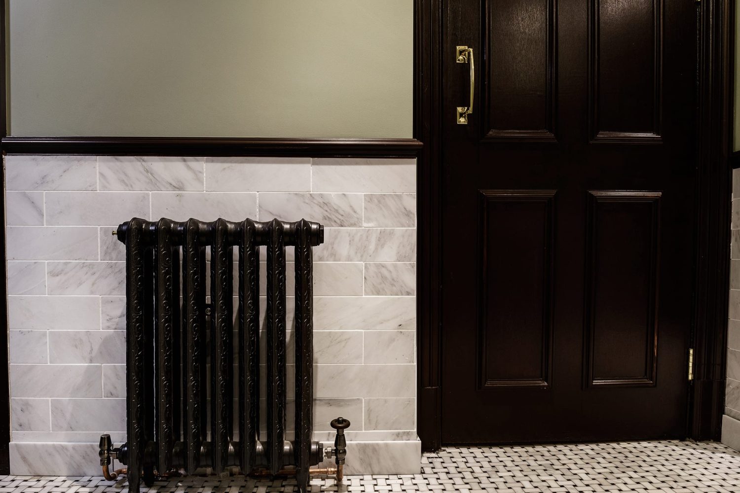 Dark silver radiator to the left of dark brown door