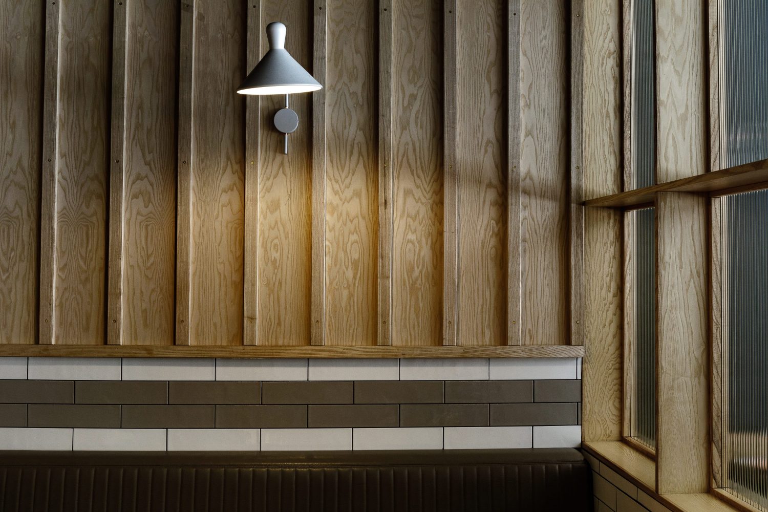 White wall lamp attached to wooden panelled wall