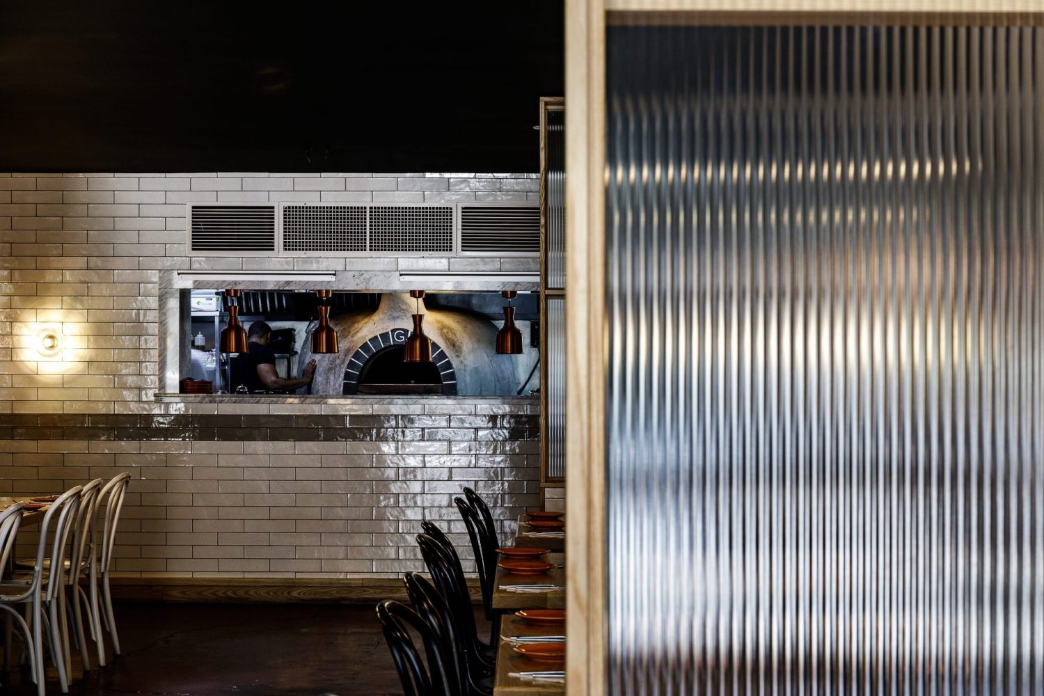 Restaurant food pass shown behind ribbed glass partition wall