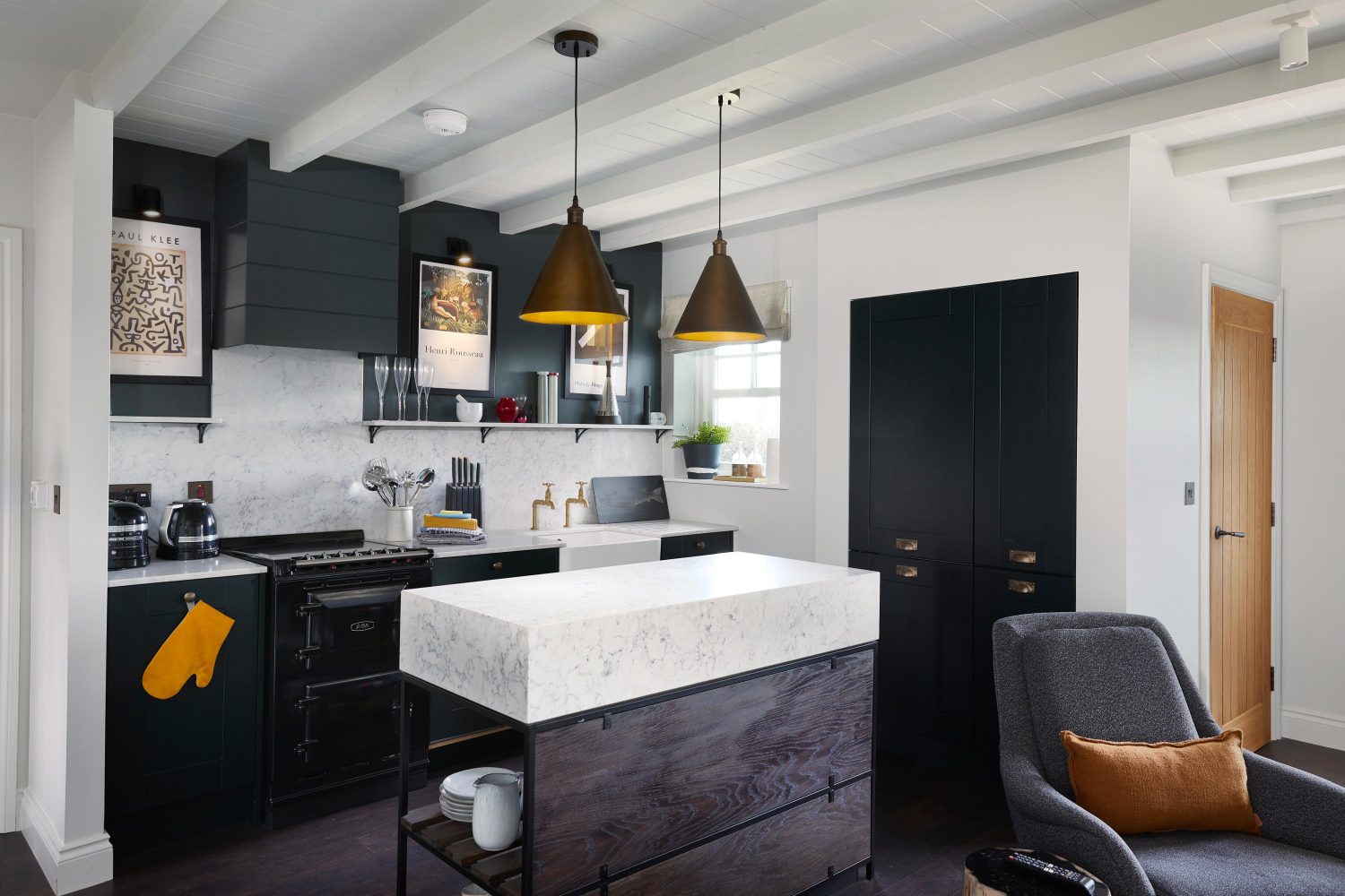 Kitchen with grey cabinets and white marble countertops and backsplash with a island in the centre