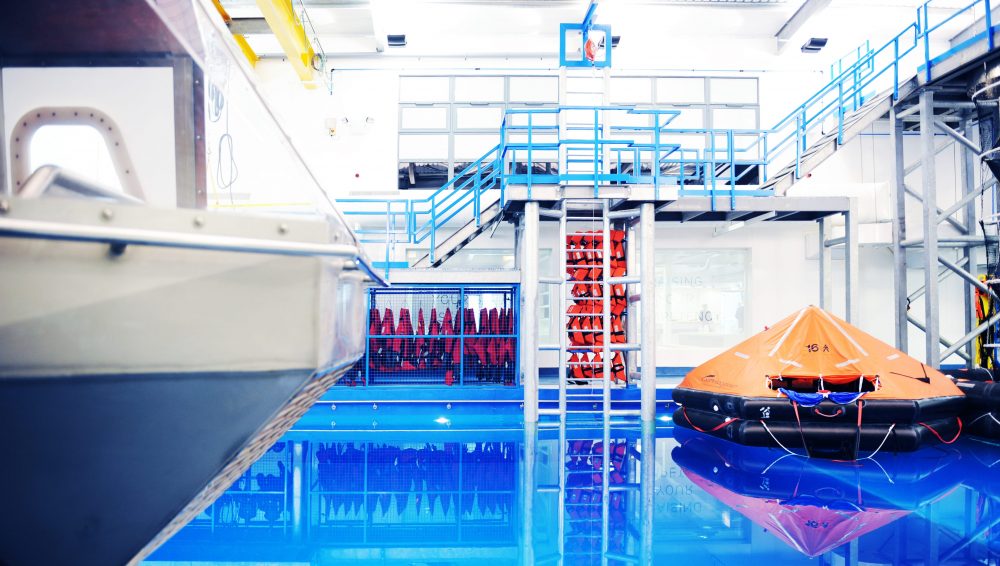 Blue pool with silver ladder in and a large orange object floating to the right