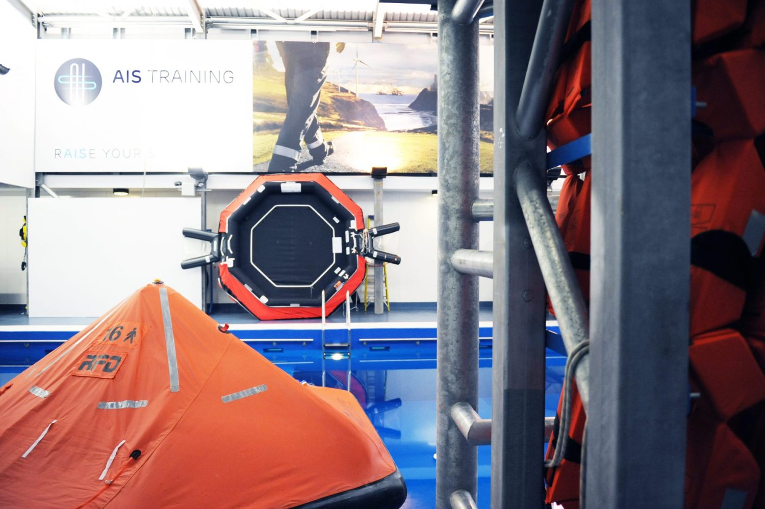 Large orange and black equipment to the side of a blue pool