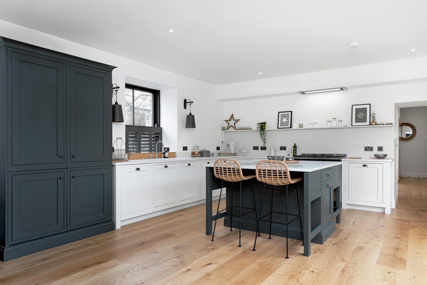 Kitchen with dark grey double door cupboard and island with white cabinetry