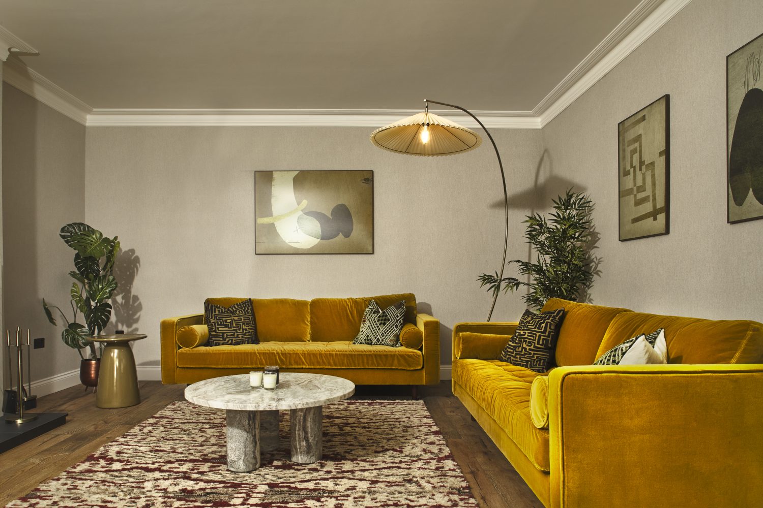 Living room with two yellow sofas and a tall standing lamp hanging over